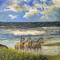 Three horses splashing through waves on a beach. The foreground has flowers & rocks. The sky has clouds.